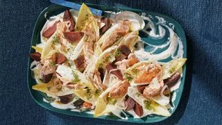 Beets flaked salmon white endives and dill on a bed of Greek yogurt sauce with horseradish.