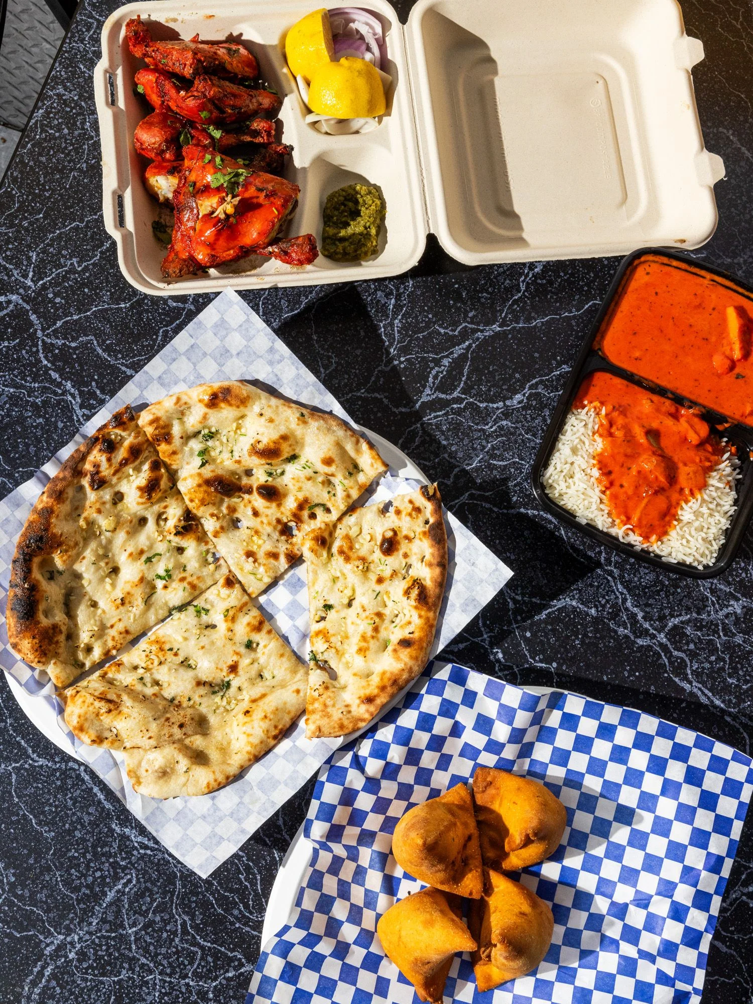 Butter chicken with a side of naan, tandoori chicken, and samosas are some of Akal’s most-ordered dishes.